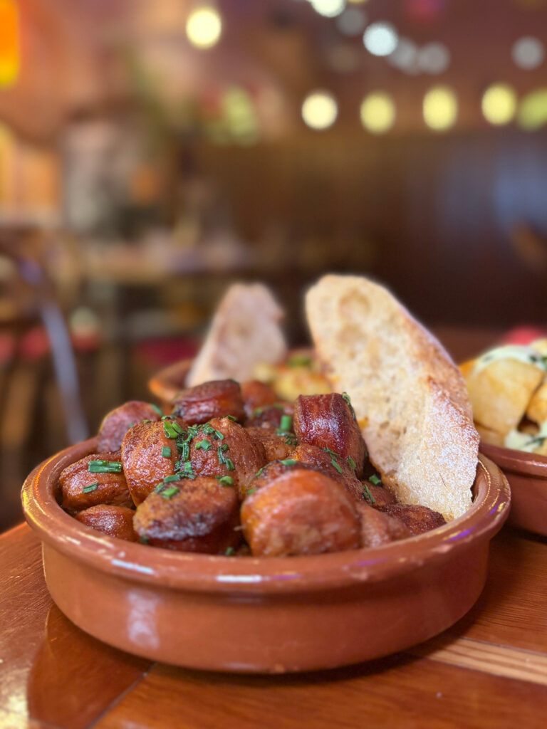 Traditional Spanish tapas with patatas bravas and chorizo in red wine served in The Market Bar Dublin.